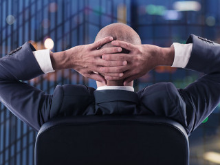 Businessman that relaxes in office and think about the future. double exposure