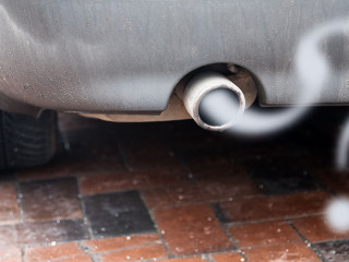 Exhaust from a car with diesel engine emitting gas in the shape