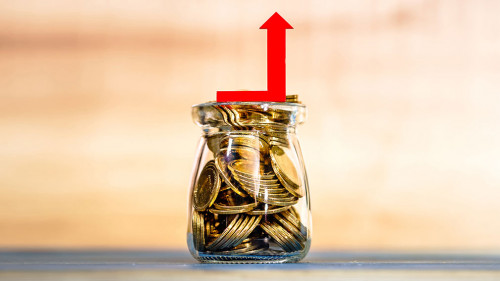 Bottle bank with gold coins inside and red arrow graph with grow