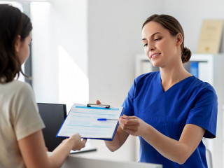 doctor with clipboard and patient at hospital