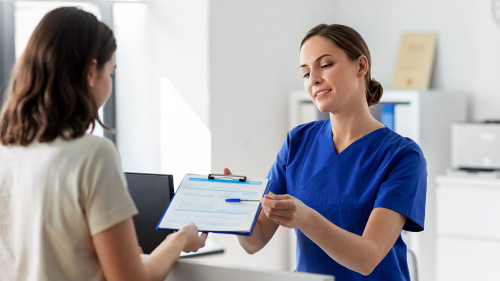 doctor with clipboard and patient at hospital