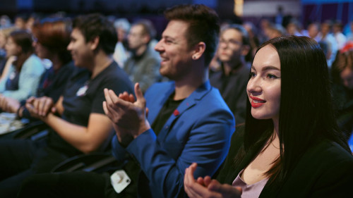 Smiling business woman applaud speaker. Seminar large audience people happy clap