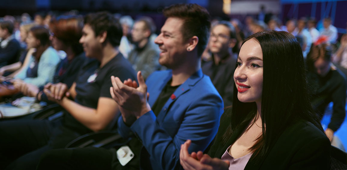 Smiling business woman applaud speaker. Seminar large audience people happy clap