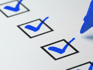 Orange marking on checklist box with pen, Checklist concept