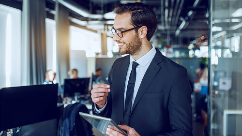 Handsome caucasian bearded smiling businessman in suit and with