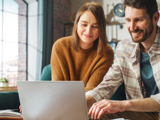 Doing Accounting at Home: Happy Couple Using Laptop Computer, Si