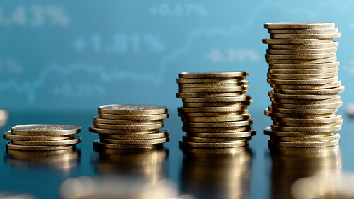 Investment and asset management yield. Stacked coins and graph.