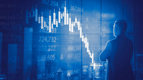 Male manager looking at declining candlestick chart