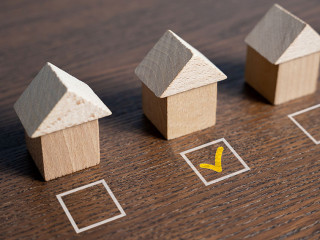 House selection. The selected house is checked with a tick. Checkbox. Difficulty of finding the perfect home. Searching for a new home. Mark the preferred choice. Real estate market offers overview.