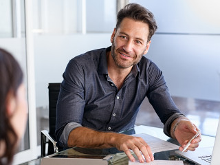 Confident businessman advising couple on finance