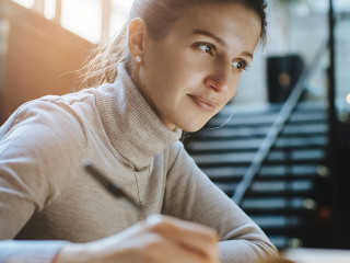 Attractive woman reading good news from business partners on lap