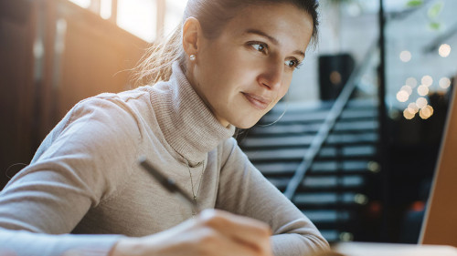 Attractive woman reading good news from business partners on lap