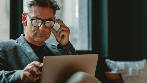 Mature male executive working in office lounge