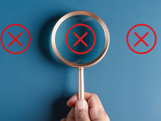 Businessman holding magnifier focus to correct icon which among wrong icon on wooden block for document and project approve, check, mark.