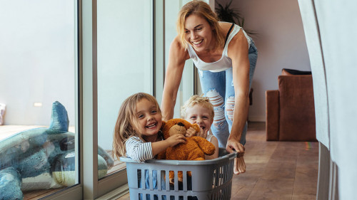 Mother playing with her children at home