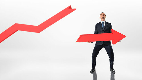 Businessman holding big broken arrow with both hands isolated on white background