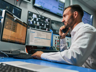 Server technician answering phone call from control room