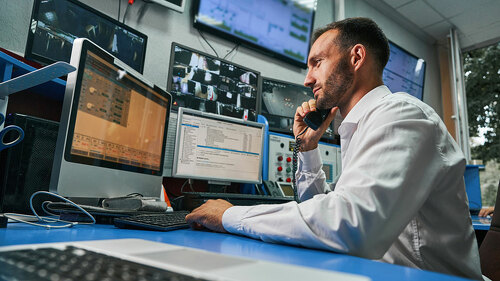 Server technician answering phone call from control room
