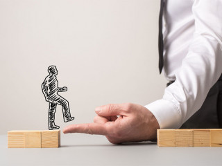 Businessman making a bridge of his finger for a silhouetted busi