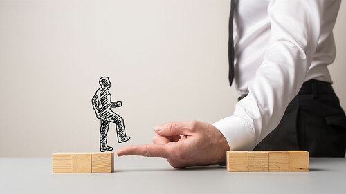 Businessman making a bridge of his finger for a silhouetted busi