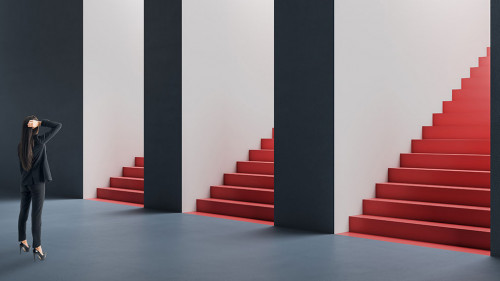 Attractive thoughtful young european woman standing in abstract concrete interior with question and confusion what entrance with staircase out of three to choose. Direction, success and choice concept.