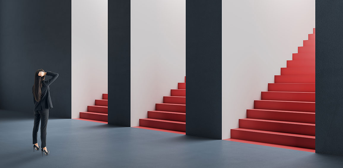 Attractive thoughtful young european woman standing in abstract concrete interior with question and confusion what entrance with staircase out of three to choose. Direction, success and choice concept.