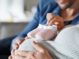 Mother and father to be at home expecting baby girl