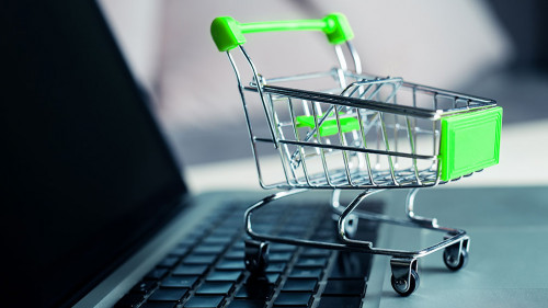 Shopping cart with laptop on the desk, online shopping concept.