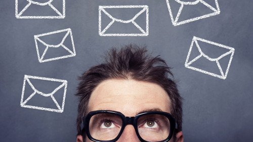 Businessman front of the blackboard with envelope signs