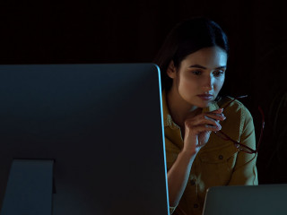 Programmer working in modern office at night