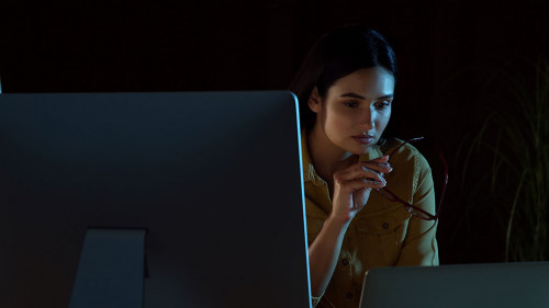 Programmer working in modern office at night