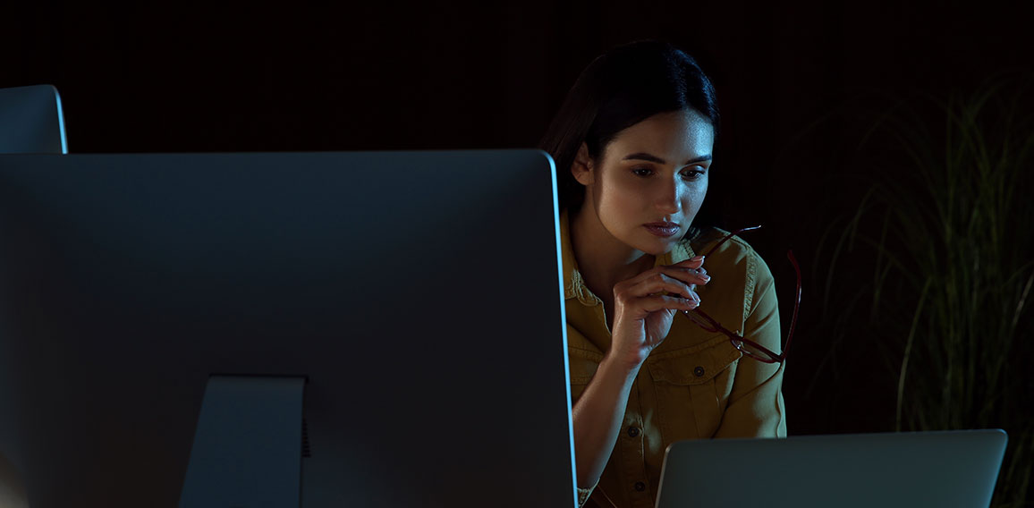 Programmer working in modern office at night