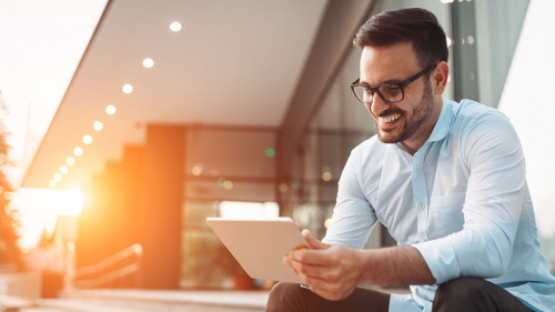 Portrait of businessman in glasses holding tablet