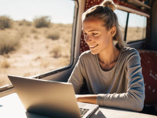 Digital Nomad Woman Using Laptop Inside Her Camper Van, Happy Developing Her Passion on a Sunny Day. Concept of Digital Nomads and Entrepreneurial Women