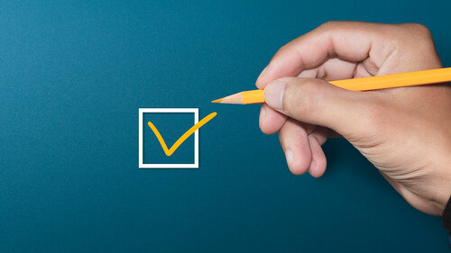 Orange marking on checklist box with pen, Checklist concept, cop