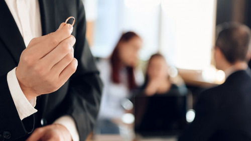 3338346 Male hands hold engagement ring. Concept of divorce of m