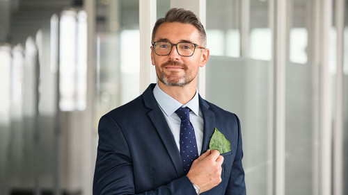 Businessman with green leaf in pocket