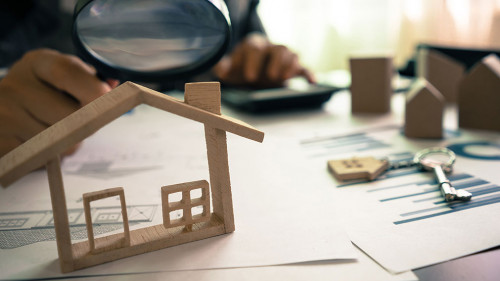 Real estate or House Appraisal using magnifying glass over the m