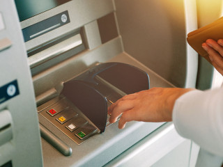 Woman pressing key pin code holding wallet