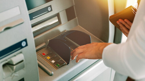 Woman pressing key pin code holding wallet