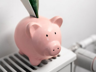 piggy bank with money on radiator at home