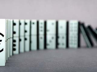 Dominoes falling in a row , gray background