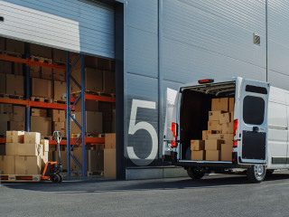 Outside of Logistics Warehouse with Open Door, Delivery Van Load