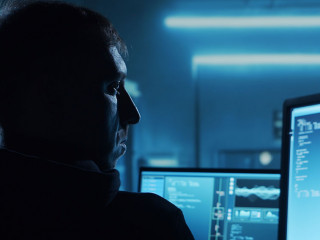 Computer Hacker in Hoodie. Obscured Dark Face. Concept of Hacker Attack, Virus Infected Software, Dark Web and Cyber Security.