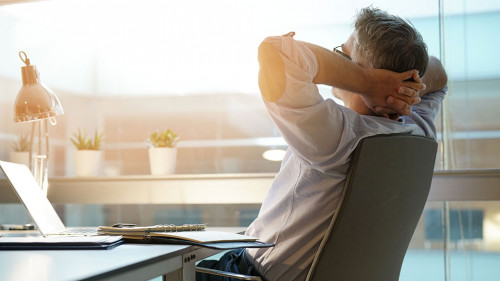 Businessman in office relaxing in chair
