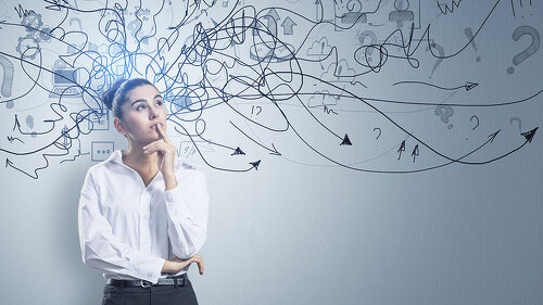 Portrait of attractive thoughtful young european businessman standing on concrete wall background with arrows mesh sketch. Confusion and question concept.