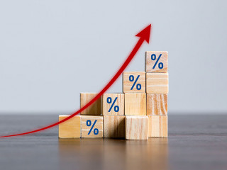 Closeup wood cubes with percentage symbol, Percent and upwards increasing arrows on wooden cubes. Financial interest mortgage rates increase or price commission raise, growth business, finance tax.
