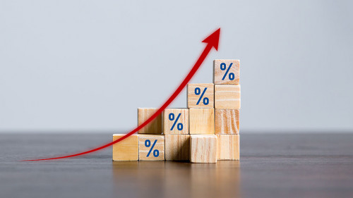 Closeup wood cubes with percentage symbol, Percent and upwards increasing arrows on wooden cubes. Financial interest mortgage rates increase or price commission raise, growth business, finance tax.