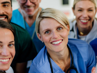Portrait of happy doctors, nurses and other medical staff in hospital.