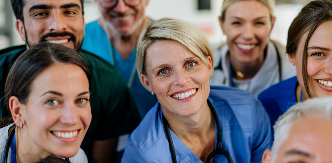 Portrait of happy doctors, nurses and other medical staff in hospital.